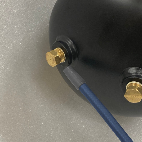 Sniffer probe testing a plug on a tank for leaks.